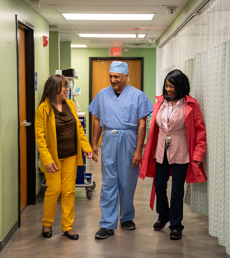 Surgeon Dr Kumar walking in the hallway of his surgical center